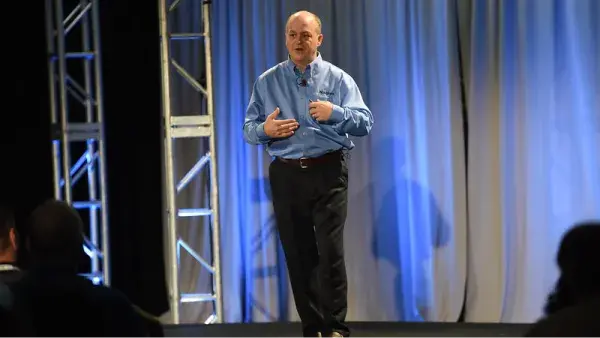 speaker standing on stage in front of audience